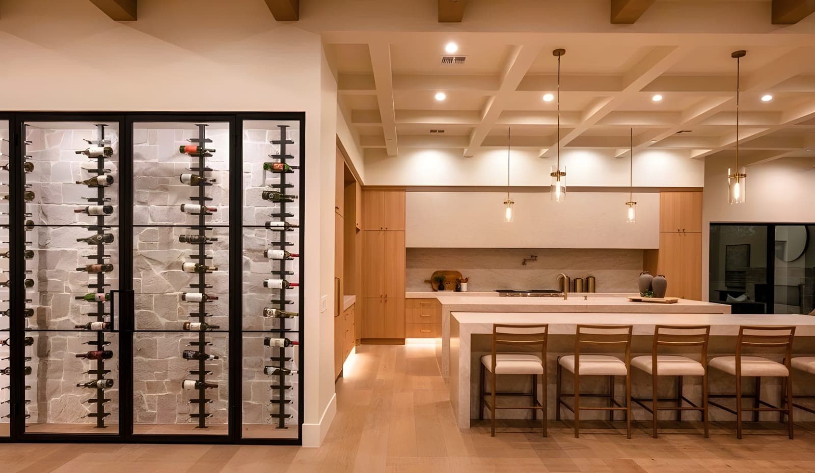 Kitchen with iron-framed glass wine display wall, stone accent wall behind bottles, white oak cabinetry, and a coffered ceiling with exposed wood beams